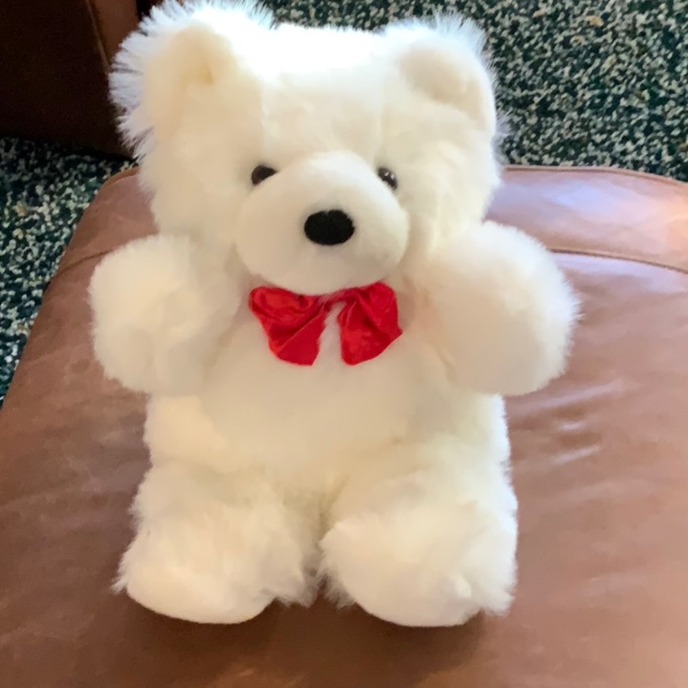Plush white stuffed bear with red bow tie